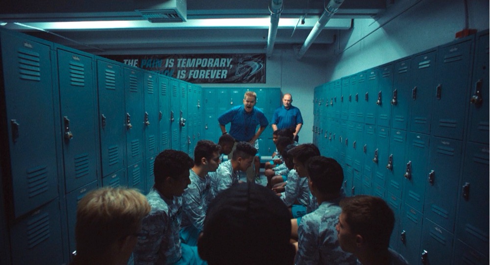 Coach addressing a team in the locker room